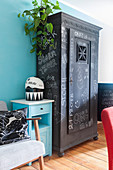 Old cupboard painted with chalkboard paint and covered in chalk lettering