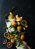 A still life with different oranges varieties on a black background