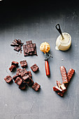 Ingredients for making sundaes: chocolate, cream, pieces of cake, chocolate bars and ice cream