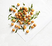 Macadamia nuts with curry powder, curry leaves and sea salt flakes