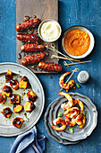 Prawns with romesco sauce; Blue cheese, pumpkin and date bites; Chipolatas with sticky mustard glaze