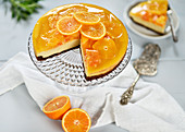 Blood orange cheesecake with a chocolate base, topped with orange slices and orange jelly (vegan)