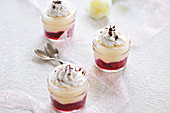 Semolina yoghurt-cream in jars with cherries and coconut cream (vegan)