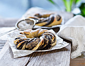 A braided yeast dough wreath filled with poppy seeds