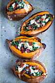Sweet potatoes stuffed with kale, prosciutto di parma and cheese