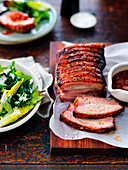 Roasted Pork belly with tomato cucumber relish and spring green salad