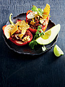Oven-roasted capsicums stuffed with hearty beef chilli and nachos