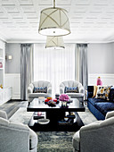 Bright living room with upholstered furniture and a dark coffee table
