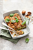 Zucchini lasagne topped with walnuts