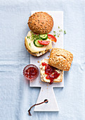 Seeded bread rolls with cheese and jam