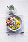 Potatoes with green sauce and cold roast pork slices