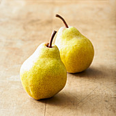 Two pears on a wooden surface