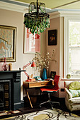 Green chandelier and desk in colourful living room