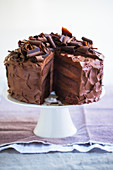 A three-layer chocolate cream cake, sliced