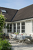 Set table in courtyard of Swedish house