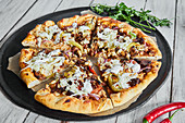 Donner kebab pizza with coleslaw and yoghurt sauce