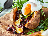 Stuffed sweet potato with rocket and poached egg