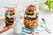 Rainbow layered salad in jars with a buttermilk dressing