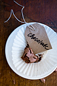 A piece of chocolate cake with a label