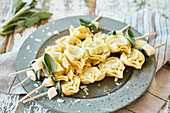 Tortellini skewers with butter, sage and Parmesan cheese
