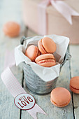 Apricot macaroons for Valentine's Day in a paper bag and in front of it