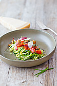 Zucchini noodles with tomatoes, olives, red shallots and capers