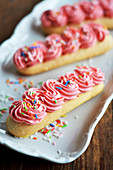Three sponge biscuits with buttercream and sugar sprinkles