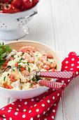 Seafood Risotto – with fish, muscles, prawns and parsley garnish; Cherry tomatoes in background