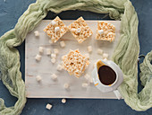 Puffed rice and marshmallow bars with caramel sauce. Top view