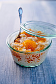 Rice pudding with tangerines in a glass