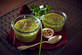 Vegetable soup with zucchini served in glass bowls