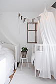 Cot with illuminated canopy in parent's bedroom