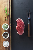Raw steak with various ingredients