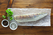 Raw zander with ingredients on a piece of paper