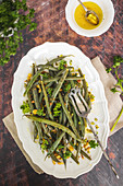 Green beans with bread crumbs oil curly parsley and pistachios