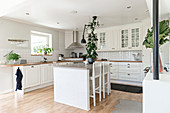 Island counter in white fitted kitchen