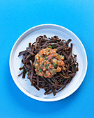 Vegan sea spaghetti with a tomato and caper sauce