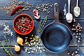 Top view of fresh herbs and spices selection over dark old wooden background