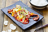 Sweet-and-sour pork served with rice and prawn crackers (China)