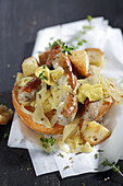 Nuremberg sausages with mustard and sauerkraut on a bread roll