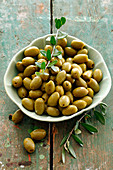 Green olives in a ceramic bowl