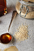 Sesame seeds and sesame oil on a spoon