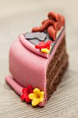 A slice of chocolate cake decorated with marzipan