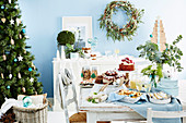 Christmas buffet in pastel blue room with Christmas tree
