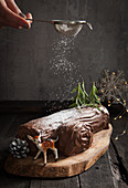 A yule log (Christmas chocolate roll) dusted with powdered sugar