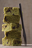 A stack of matcha brownies with chocolate chips