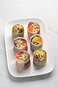 Spring rolls with various fillings on a serving platter (Asia)