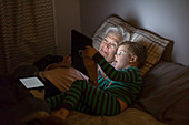 Grandmother and grandson using tablet computer