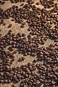 Coffee beans against a hessian background