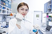 Lab assistant using pipette